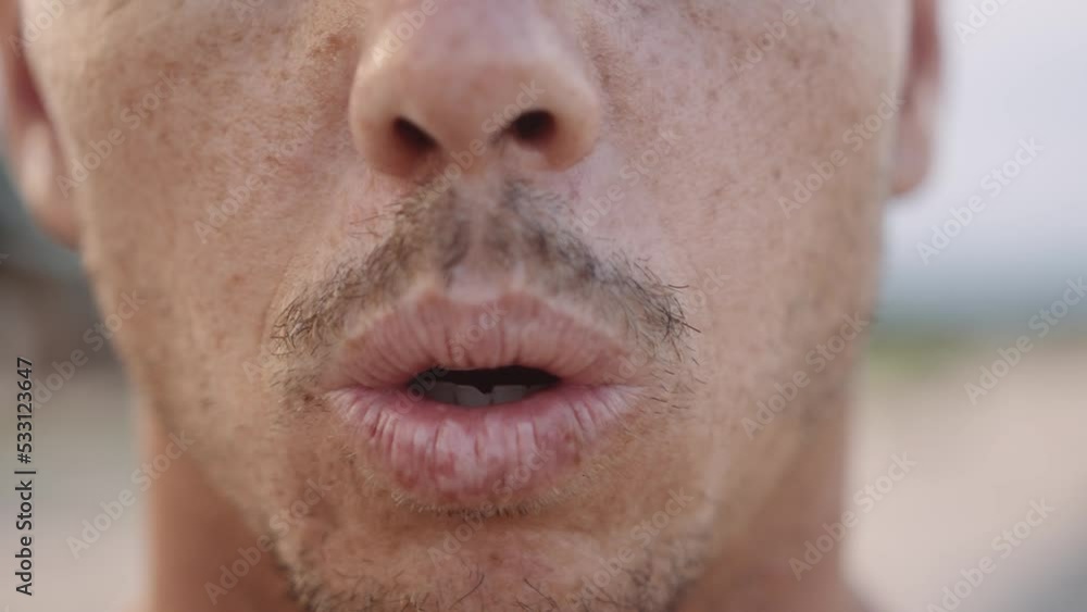 Close-up of young caucasian man with stubble breathing on beach Close-up of young caucasian man with stubble breathing on beach