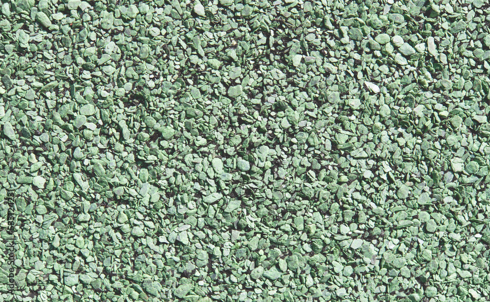Soft rubber granular flooring surface close up big grain green colored Soft rubber granular flooring surface close up big grain green colored
