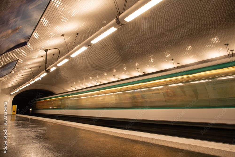 Paris, France. August 2022. A subway station with a passing train in Paris.