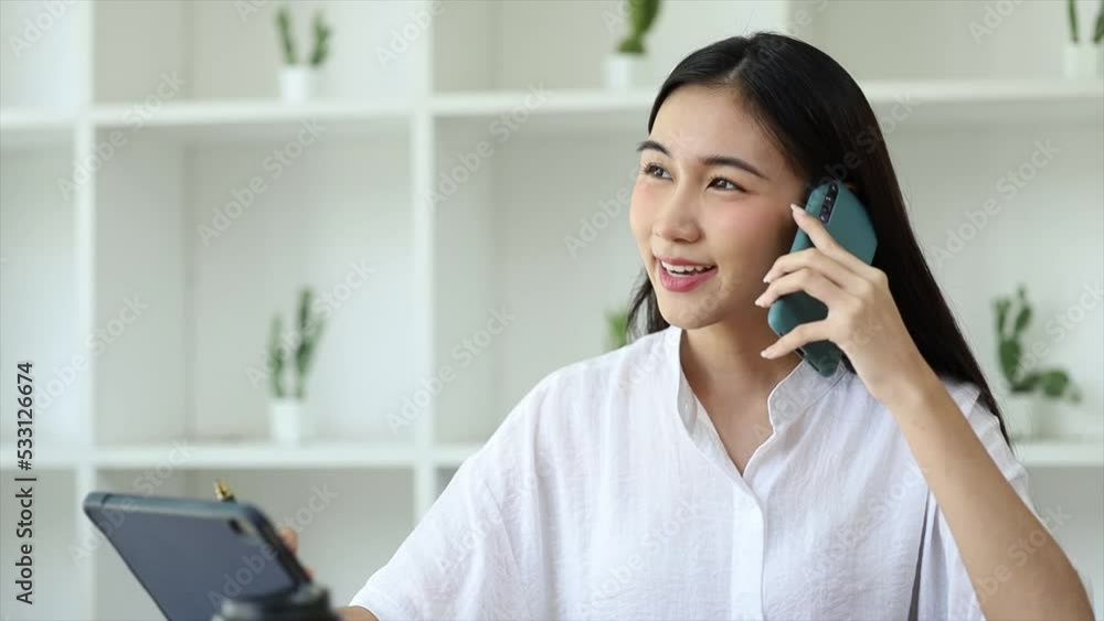 Beautiful Asian woman executives, business executives, marketing executives are talking on the phone with customers to contact the company for marketing. Marketing management concept. Beautiful Asian woman executives, business executives, marketing executives are talking on the phone with customers to contact the company for marketing. Marketing management concept.