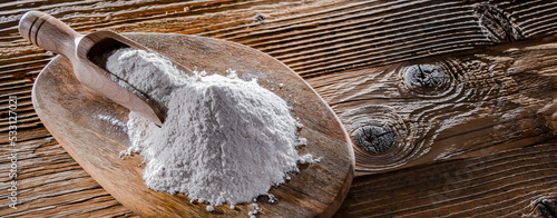 Wheat flour on the wooden cutting board