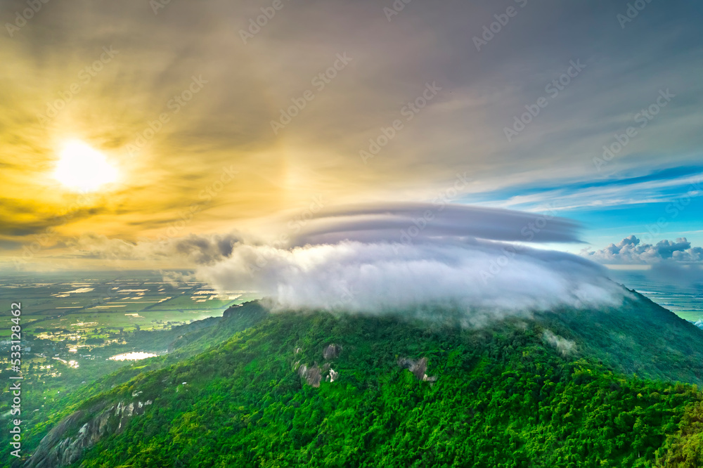 Morning on the top of Tri Ton mountain, An Giang, Vietnam when the clouds cover and the sun rises to welcome a peaceful new day in the border region of Vietnam