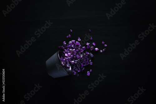 amethyst chips macro detail black background. close-up polished semi-precious gemstone copy space top view backdrop.
