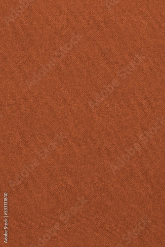 Bright brown colored paper texture. Dark orange tinted background. Vertical wallpaper. Textured surface, fibers and irregularities are visible. Top-down