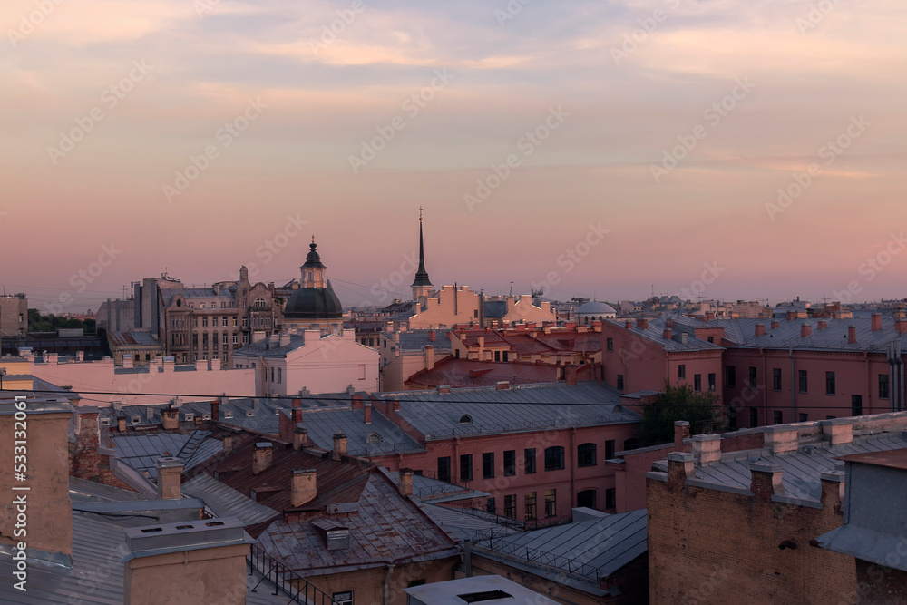 A shot from a roof of a Saint Petersburg cityscape against the sky in summer evening