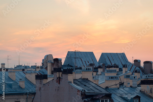 A shot from a roof of a Saint Petersburg cityscape against the sky by summer day