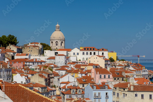 Typical cityscape of Lisbon, Orange brick roof top of building and housing in old town with harbor view, Narrow houses between small street in coastal of atlantic, Lisbon is capital city of Portugal.