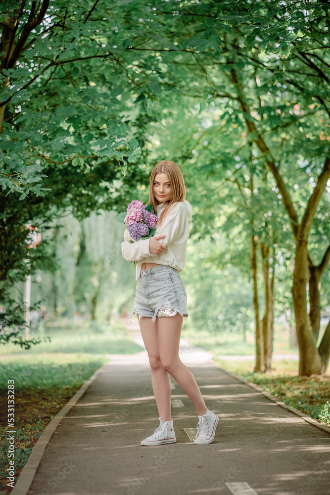 beautiful fair-haired girl on a bicycle with flowers. Hydrangeas. beautiful fair-haired girl on a bicycle with flowers. Hydrangeas.