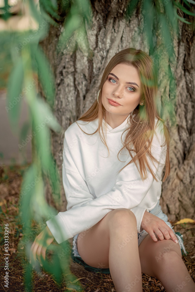 beautiful fair-haired girl outside among the trees beautiful fair-haired girl outside among the trees