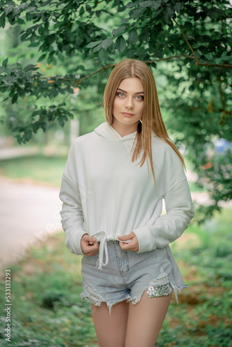 beautiful fair-haired girl outside among the trees