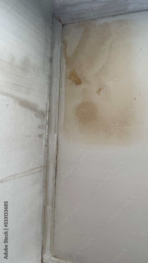  white room is water leaks on the ceiling of the room.