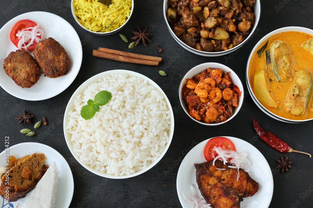 Rice and non vegetarian curry for Christmas special food in Kerala India. Indian pork fish beef prawns curry with white rice cutlet  appam.