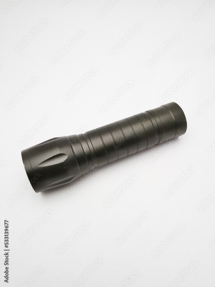 small black police flashlight on a white background small black police flashlight on a white background