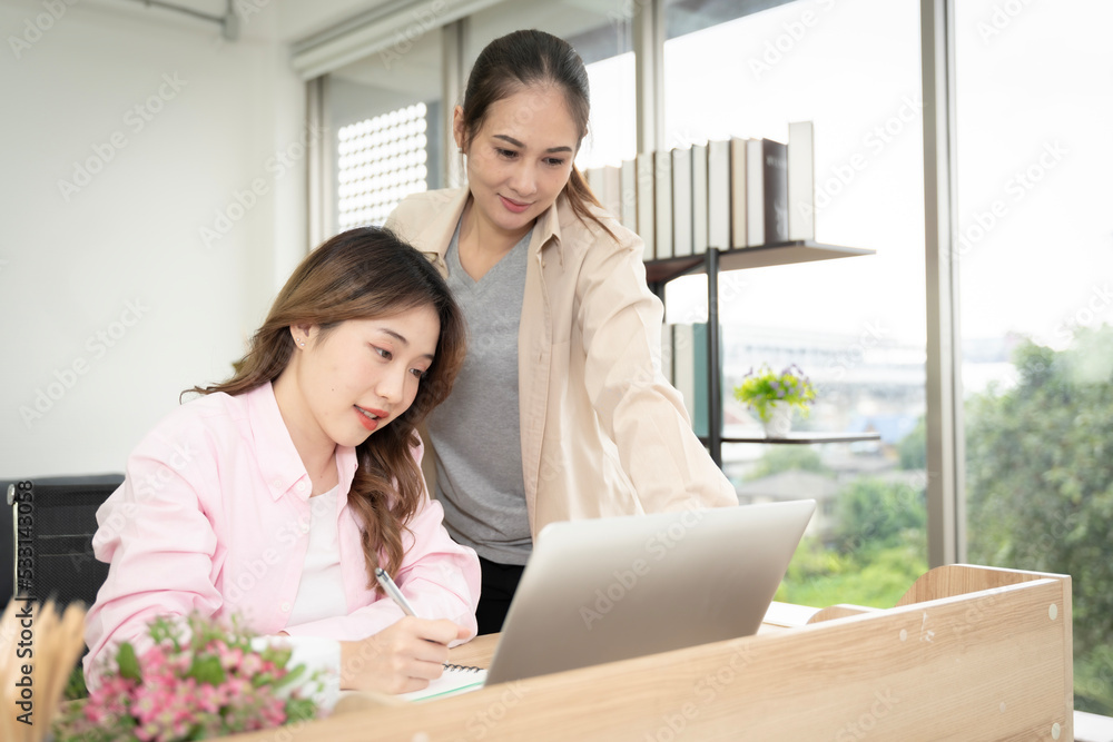 Asian woman sitting at home working in the bedroom take notes of the meeting Record work with a notebook. Cheerful, fun at work. Asian woman sitting at home working in the bedroom take notes of the meeting Record work with a notebook. Cheerful, fun at work.