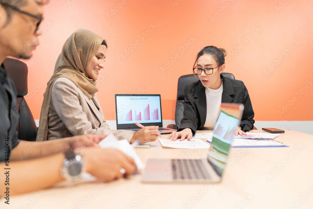 Fototapeta premium business muslim and asian woman and man have meeting. office woman explain project plan in future for organization and worker to work. talking team sitting in conference room to debate about company