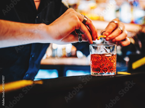 man bartender hand making negroni cocktail