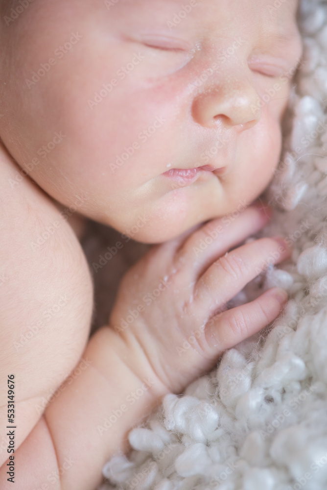 A cute little baby sleeps on a white bouclé bedspread at home. Health and motherhood
A cute little baby sleeps on a white bouclé bedspread at home. Health and motherhood