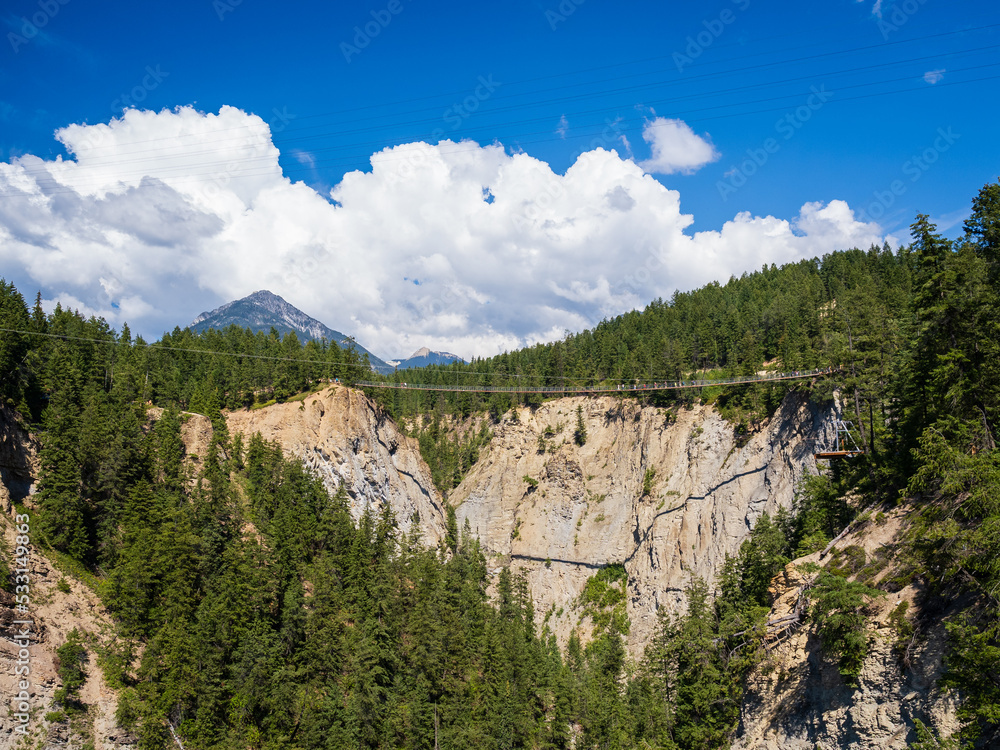canyon in the rocky mountains with suspension bridge across