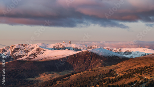 First snow on the peak of the Koralpe and first rays of sun on a cold winter morning in Austria