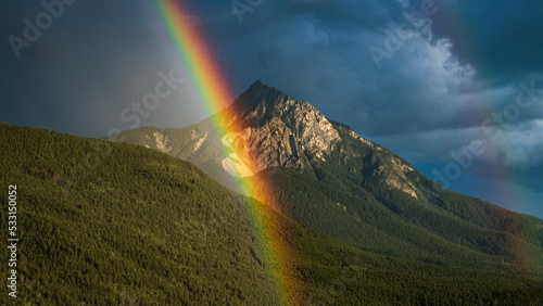 rainbow over the rocky mountains in bc canada