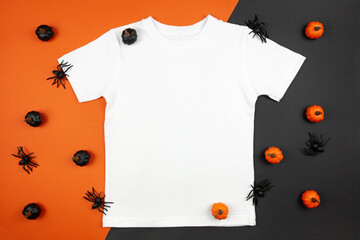 White womens cotton t-shirt halloween mockup with pumpkins and spiders on black orange background. Design t shirt template, print presentation mock up. Top view flat lay.