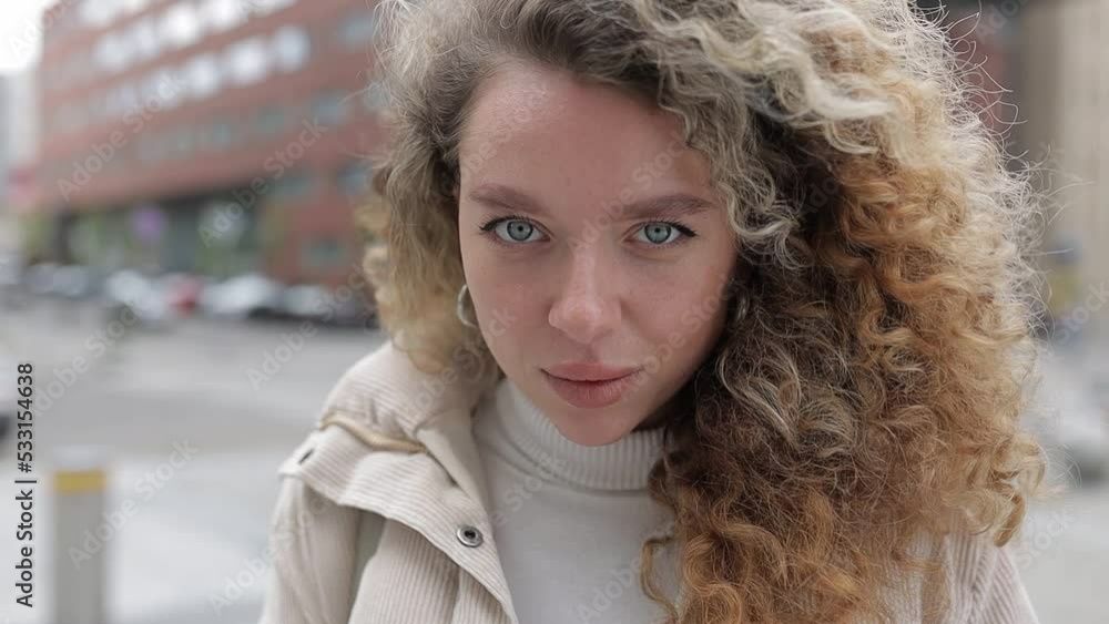Portrait of Smiling Young Woman on Urban Background. Cheerful Girl Smiling and Looking at Camera Portrait of Smiling Young Woman on Urban Background. Cheerful Girl Smiling and Looking at Camera