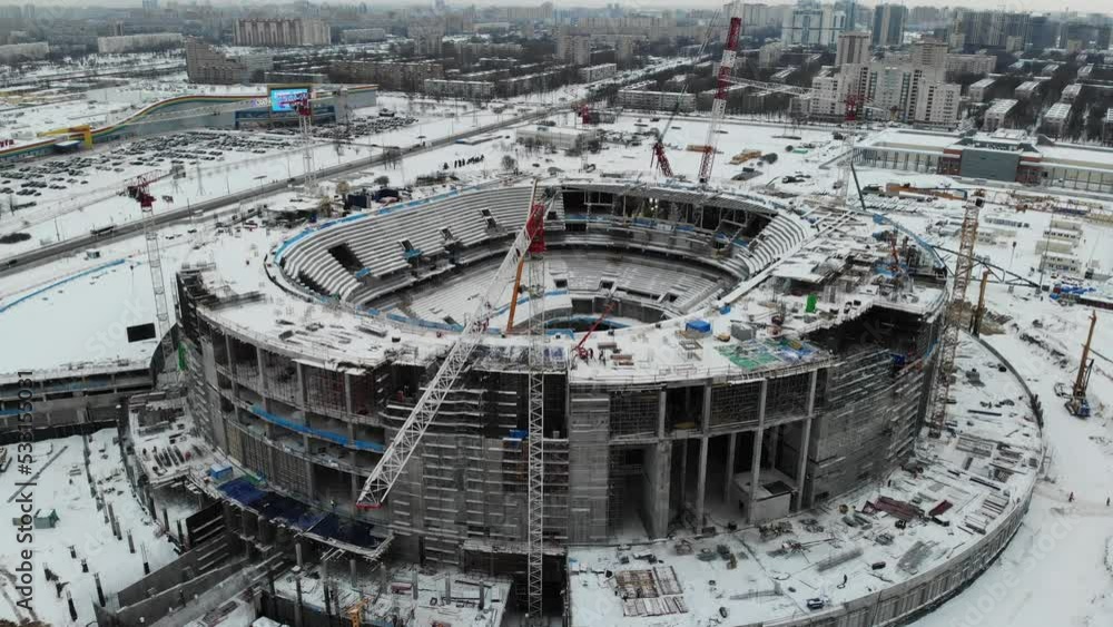 Building construction of SKA arena hockey stadium ex Saint Petersburg Sports and Concert Complex. Winter. Aerial drone view. Flying over. Drone is moving sideways forward. High quality 4k footage Building construction of SKA arena hockey stadium ex Saint Petersburg Sports and Concert Complex. Winter. Aerial drone view. Flying over. Drone is moving sideways forward. High quality 4k footage