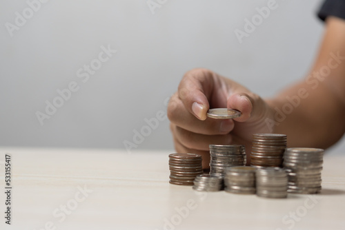 Finance investment saving wealth person holding a stack of coins business currency banking cash growth money.