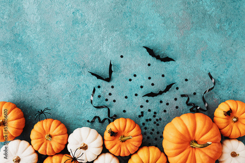 Leinwand Poster Halloween holiday card with party decorations of pumpkins and bats on blue table top view