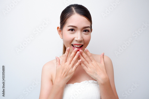 Face of a beautiful Asian woman with good skin hand touching face Facial treatments, facials, facials, beauty, cosmetics, and spas.