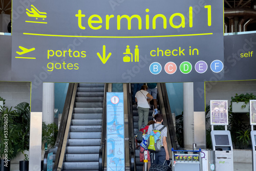 Passengers walking inside the International airport in Lisbon photo