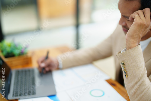 Portrait of sme business owner, man using computer and financial statements Anxious expression on expanding the market to increase the ability to invest in business