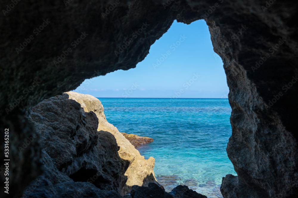Grotta del Palombaro in cliff and transparent clear sea water. Tropea beach along Tyrrhenian sea, Coast of Gods, Calabria, southern Italy.