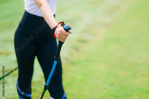 female legs with trekking poles. Nordic walking. hiking. travel concept.