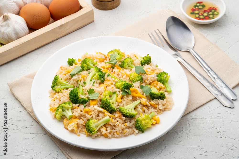 Fried rice with broccoli and egg in white plate.Easy food Fried rice with broccoli and egg in white plate.Easy food