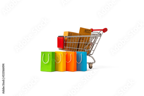 Shopping cart with package boxes and shopping bag isolated on white background