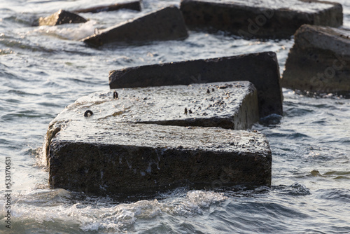large stones in the water to protect the shore from erosion photo