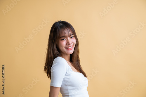 Young attractive Asian woman isolated on yellow background