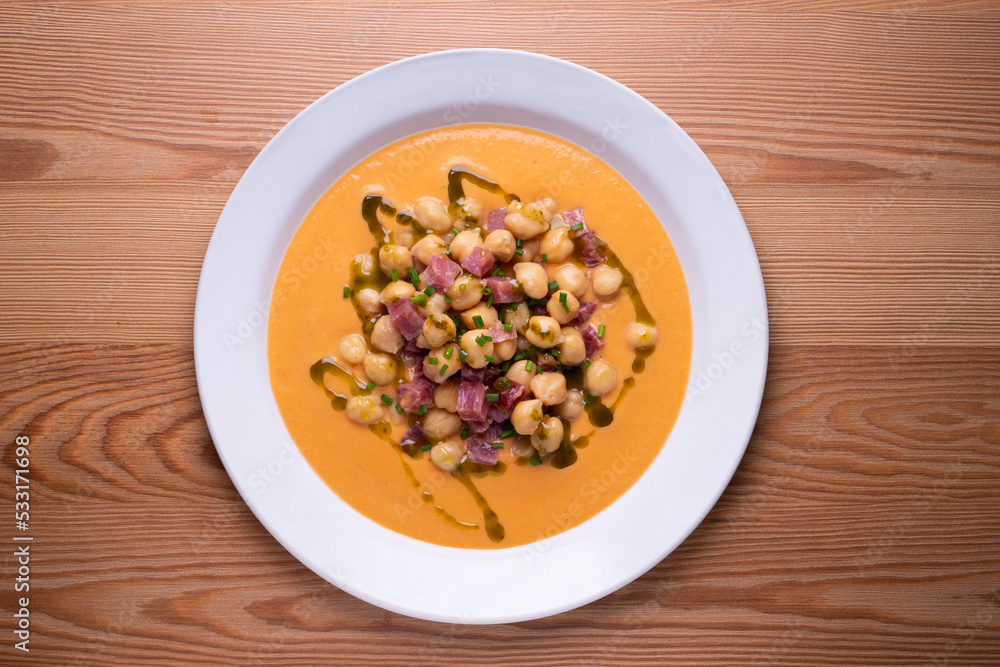 Salmorejo with chickpeas and ham. Typical Spanish cold soup recipe made with tomatoes and vegetables. Traditional tapas from the south of Spain. Salmorejo with chickpeas and ham. Typical Spanish cold soup recipe made with tomatoes and vegetables. Traditional tapas from the south of Spain.