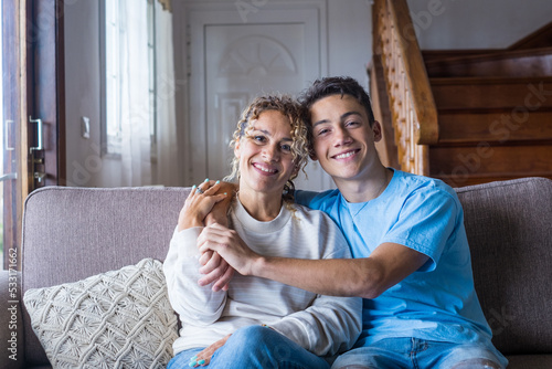 Slika na platnu Portrait of grateful teenager man hug smiling middle-aged mother show love and care, thankful happy grown-up son in embrace cheerful mom, enjoy weekend family time at home together, bonding concept