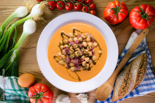Salmorejo with chickpeas and ham. Typical Spanish cold soup recipe made with tomatoes and vegetables. Traditional tapas from the south of Spain.