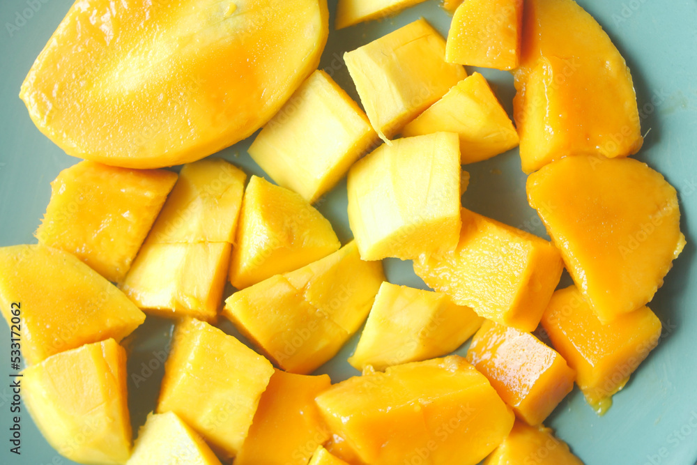  yellow ripe cut mango in a bowl top down 