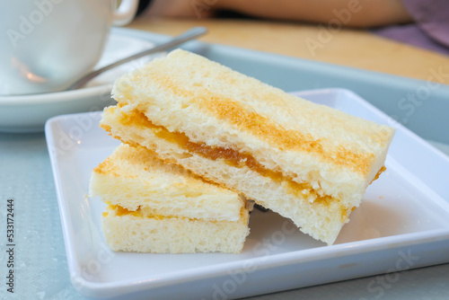 kaya toast with a cup of tea on table  photo