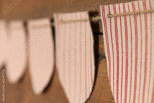 Close up of Rustic Red and White Burlap Festive Holiday Bunting on Twine