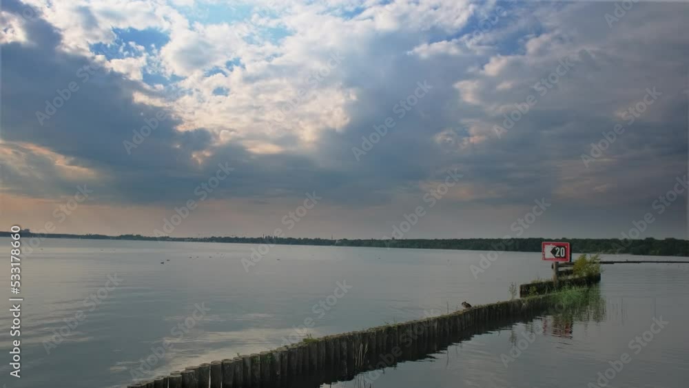 Beautiful reflexion on a lake of a cloudy sky during a sunset. Blue sky with some clouds during a sunset. Beautiful reflexion on a lake of a cloudy sky during a sunset. Blue sky with some clouds during a sunset.