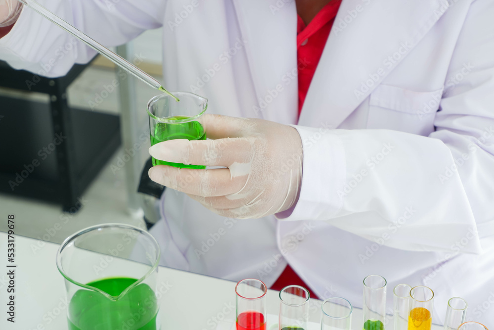 Scientist use of Dropper and Beaker in the laboratory. Scientist use of Dropper and Beaker in the laboratory.