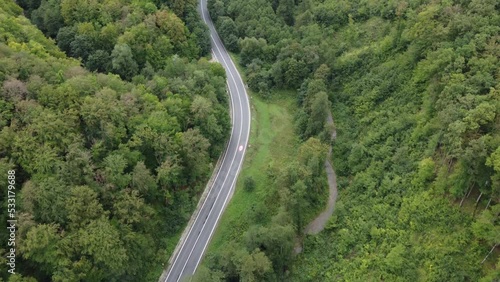 Wallpaper Mural drone footage with road in the mountains with green trees following cards Torontodigital.ca