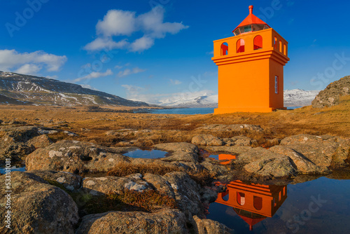 Djupivogur Lighthouse  is located on the southeast coast of Iceland, on a rocky point on the west side of the port of Djúpivogur. photo