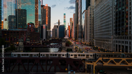 aerial drone view of the Chicago river during sunset and Chicagohenge. during golden hour the sun is clearly visible in the sky due to the fall equinox as people go about their commute 