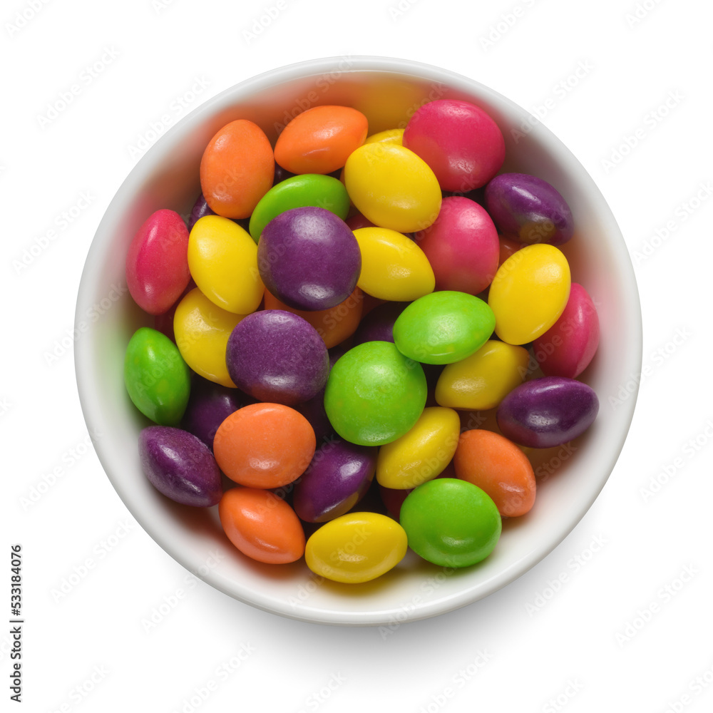 Colorful round candies in white bowl isolated on white. Top view. Colorful round candies in white bowl isolated on white. Top view.